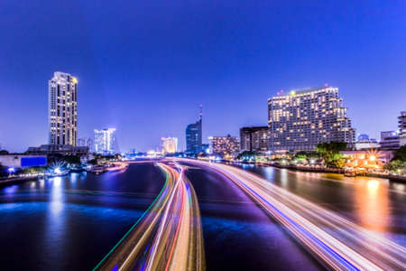 Abstract blurred Background of Light effects over time after sunset on the river : Bangkok city, Thailand.の写真素材