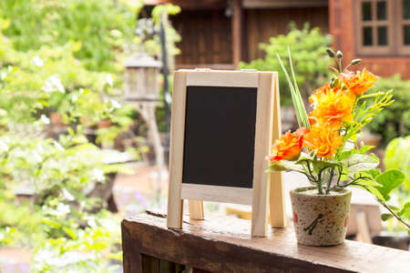 Empty menu advertising board and flower vase in home stayの写真素材