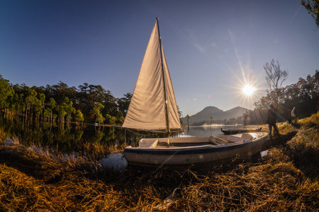 Sailing boat on the lake at sunset in Tasmania, Australia.の写真素材