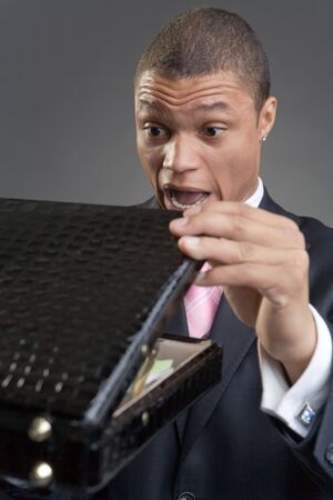 The businessman with a briefcase on a dark background