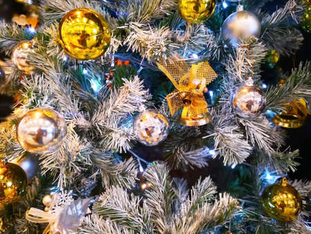 Close-up many beautiful golden shiny balls, silver ball  and mirror balls, which are decorated on...