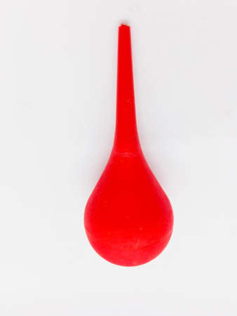 Medication concept, red rubber used for sucking sputum and nasal mucous,  isolated on white background with clipping path.の写真素材