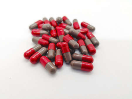 medication and healthcare concept. Many grey-red capsules of Flunarizine 5 mg. isolated on white...