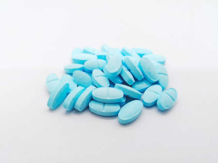 Medication and healthcare concept. Many oval blue pills of Prednisolone 5 mg. isolated on white background, It prevents the release of substances in the body that cause inflammation. Selective focus and copy space.の写真素材
