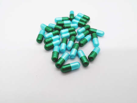 Medication and healthcare concept. Many green-blue capsules of Amoxicillin 500 mg. Focus on...