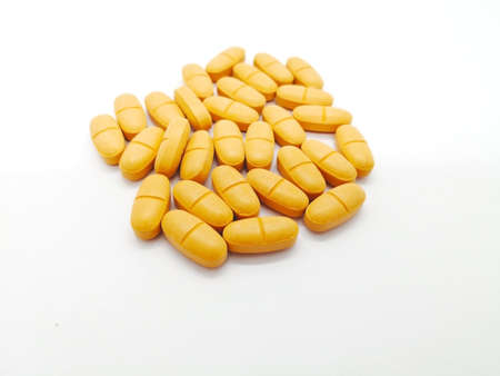 Medication and healthcare concept. Many orange tablets of Ibuprofen 400 mg.  Focus on foreground and...
