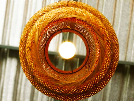 The concept of handmade natural decorations. Handmade bamboo lantern, decorated for light on the ceiling. Selective focus and copy space.の写真素材