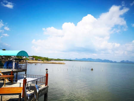 Natural seashore background concept. The daytime blue sky is surrounded by the sea, filled with...