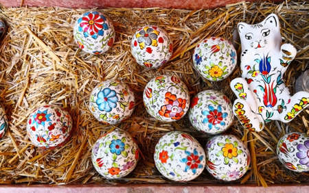 Religion and Easter day concept. Ceramic kitten and easter eggs, which are painted in bright colors....