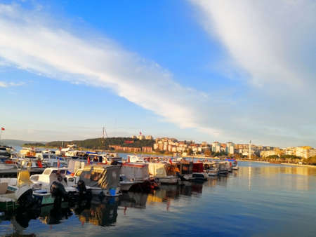 The harbor in Canakkale, Turkey-March 31, 2018: Many small motorboat are neatly  moored in the small bay, which the opposite side is full of buildings. Selective focus and copyspace.のeditorial素材