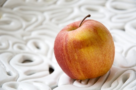 apple on texture white bowlの写真素材