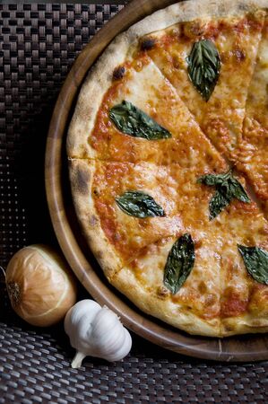 tasty sliced fresh pizza Margherita on wooden panの写真素材