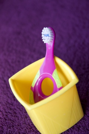 toothbrush for kid put on yellow box in bathroomの写真素材