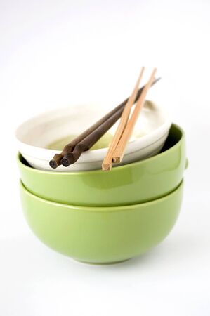 three stack of bowls with chopsticks on white backgroundの写真素材