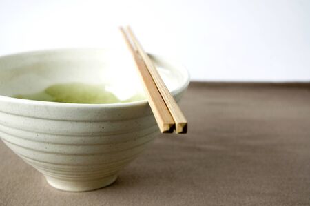 japanese bowl with chopstick on brown color backgroundの写真素材
