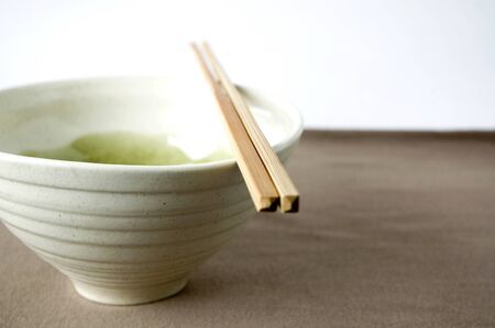 japanese bowl with chopstick on brown color backgroundの素材 [FY31015441951]