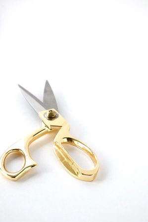 close up golden scissors on white backgroundの写真素材