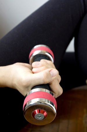 sporty woman is working out with dumbbellの写真素材