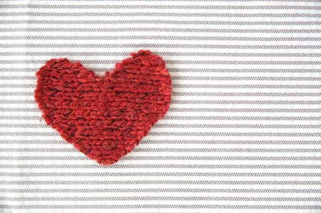 red heart on striped fabric backgroundの写真素材