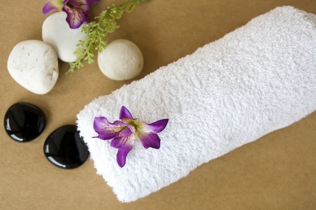 orchid put on towel spa on brown backgroundの写真素材