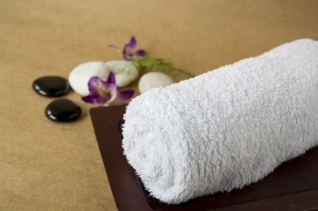 white roll of towel with orchid backgroundの写真素材