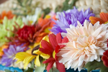 mixed blooming artificial flowers backgroundの写真素材