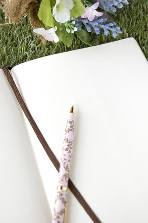 paper page put on grass with bouquet flowerの写真素材