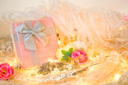 pink gift box with roses and white feather backgroundの写真素材