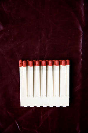 red matches on deep red backgroundの写真素材