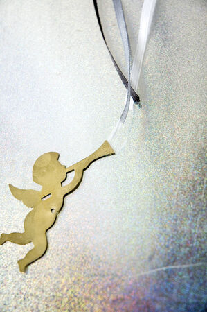 golden angel blowing blue ribbon の写真素材