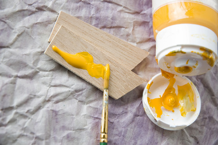 yellow acrylic color on woodenの写真素材