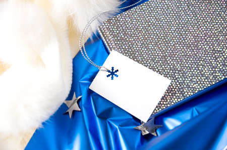 blank gift card on shiny silver and blue backgroundの写真素材