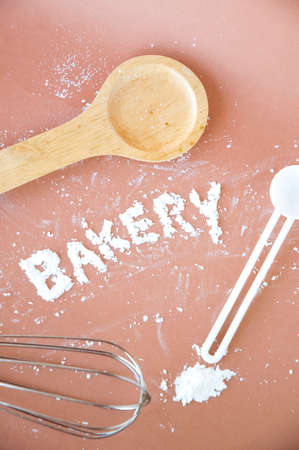 bakery wording and kitchen utensil on pink background