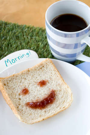 smiley bread and coffee with morning note for breakfastの写真素材