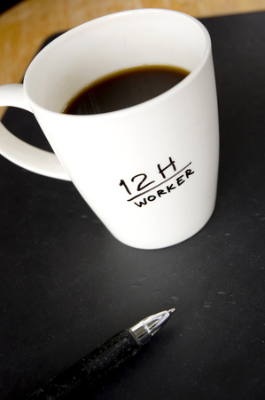black coffee in white cup for overtime workerの写真素材