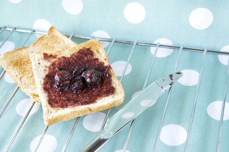 black cherry jam on wheat bread toastの写真素材