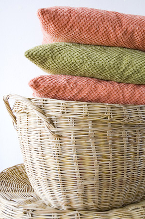 orange and green color pillow put on basketの写真素材