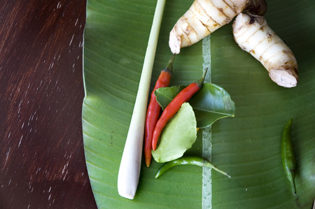 red chili and tomyum ingredients on banana leafの写真素材