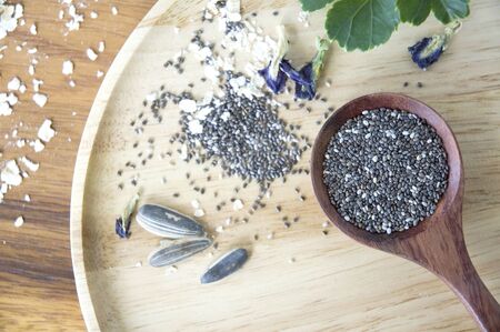 chia seed in spoon put on wooden tray with natural seedsの写真素材