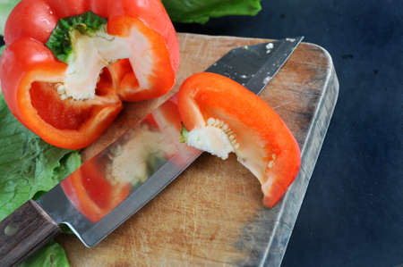 red bell pepper on wooden cutting boardの写真素材
