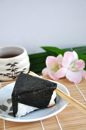 Onigiri Japanese food on dish with chopstickの写真素材