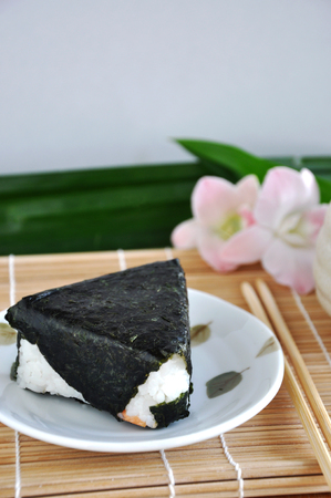 Onigiri Japanese food on dish put on bamboo matの写真素材