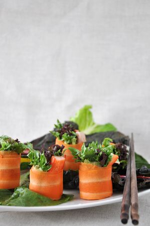Carrot Rolls dish on white background with chopstickの写真素材