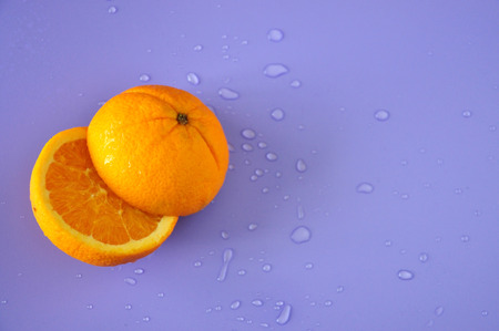 Top view of cut half navel orange on purple backgroundの写真素材