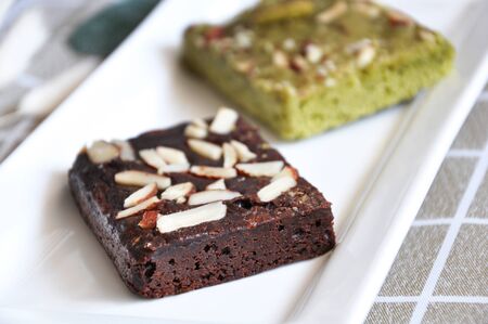 Close up dark chocolate fudge brownie on white plateの写真素材