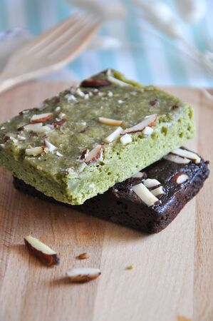 Stack of healthy green tea and dark chocolate fudge brownies on wooden boardの写真素材