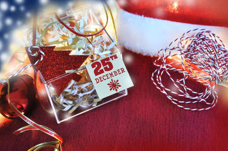 Christmas decoration concept. Paper tag on Christmas date and paper tag red Christmas tree shape put...