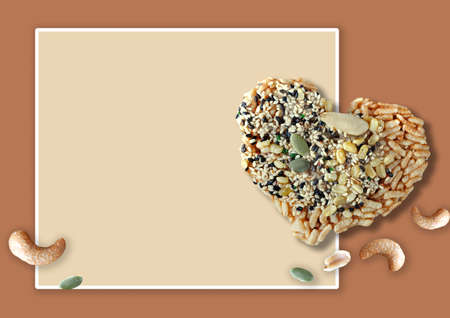 Healthy snack rice cracker with nuts and natural seed in heart shape on neutral color background with space for textの写真素材