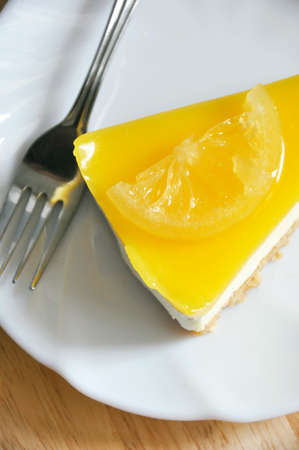 Above of lemon cheese tart on white dish with forkの写真素材