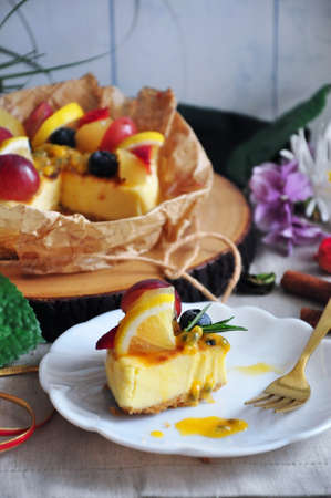 Close up A Piece of New York Cheesecake topping with Passion Fruit Sauce on white dishの写真素材